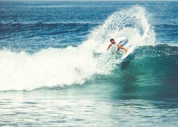 Men and girls surf the island of Bali