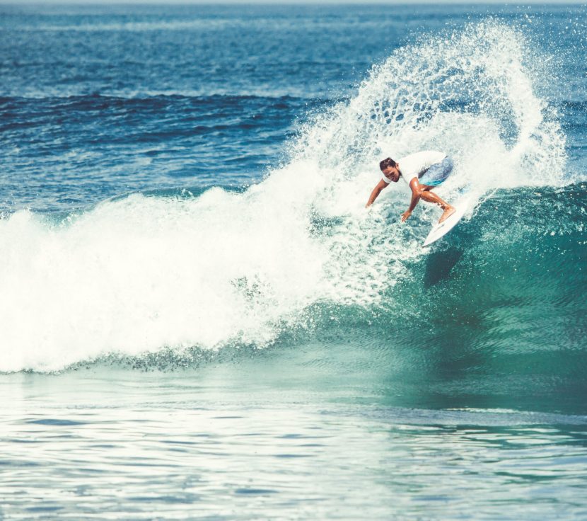 Men and girls surf the island of Bali